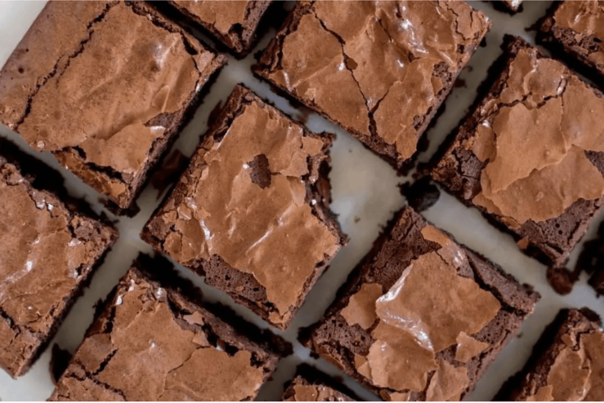 Freshly baked brookies with a chewy cookie layer and fudgy brownie topping, cut into squares.